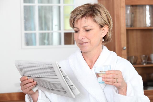 Woman drinking water at breakfast