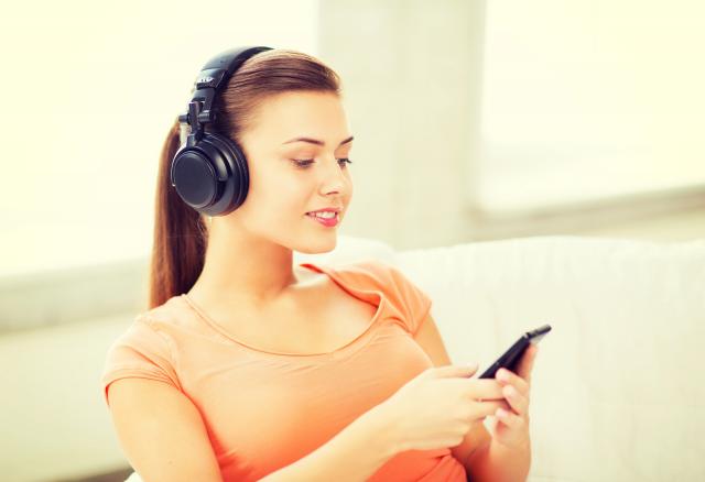 Woman listening to music through headphones