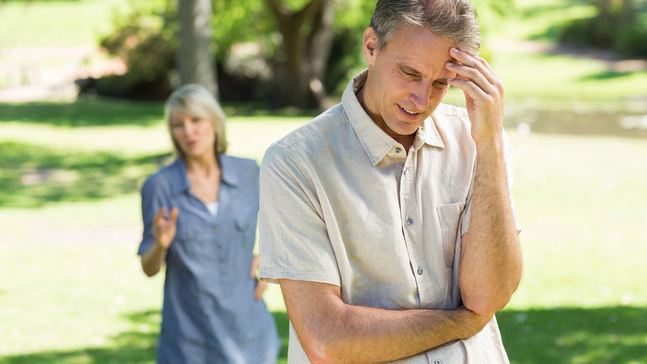 Man walks away from woman in frustration