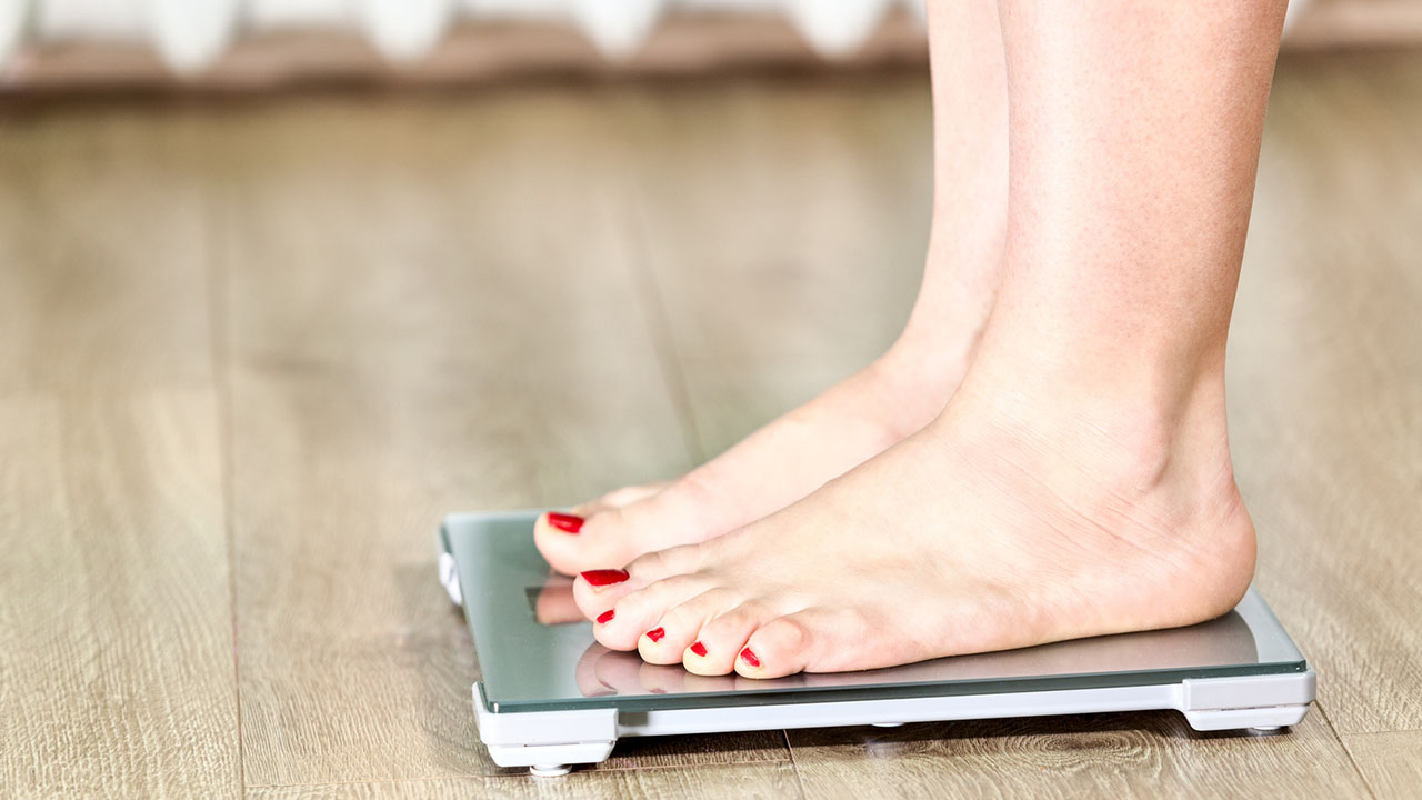 Female feet on a bathroom scale