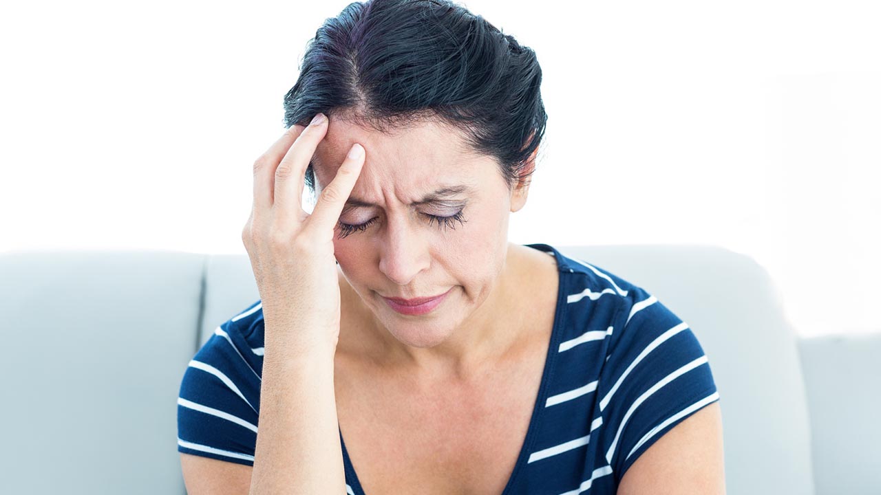 woman suffers anxiety, headache