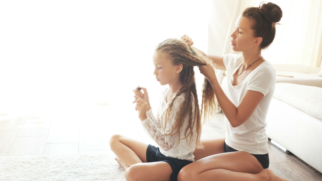 mom brushing daughter's hair