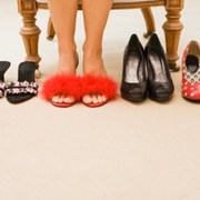 sore-feet-wearing-slippers-beside-shoes